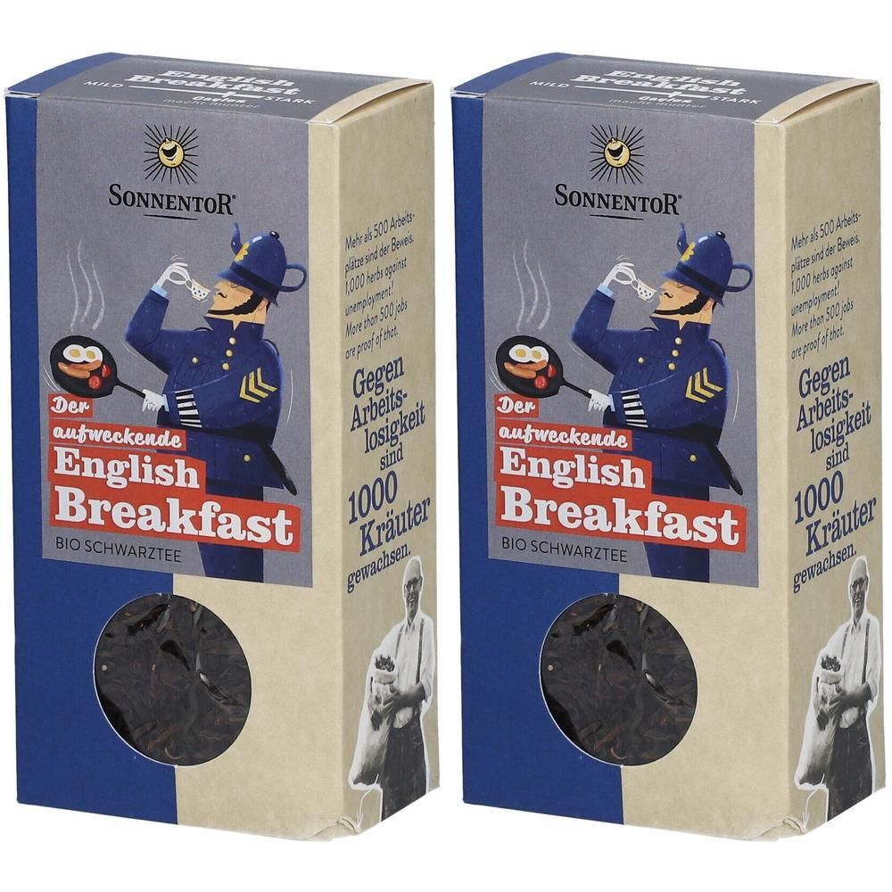 Zwei Kartons Sonnentor English Breakfast Tee. Aufdruck mit Illustration eines Polizisten und Produktname. Sichtfenster mit Tee.