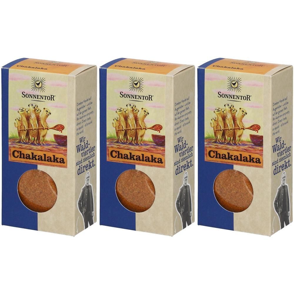 Drei rechteckige Kartons mit Produkt. Aufschrift: Chakalaka. Marke: Sonnentor. Illustration von Erdmännchen. Sichtbares Produkt in der Mitte.