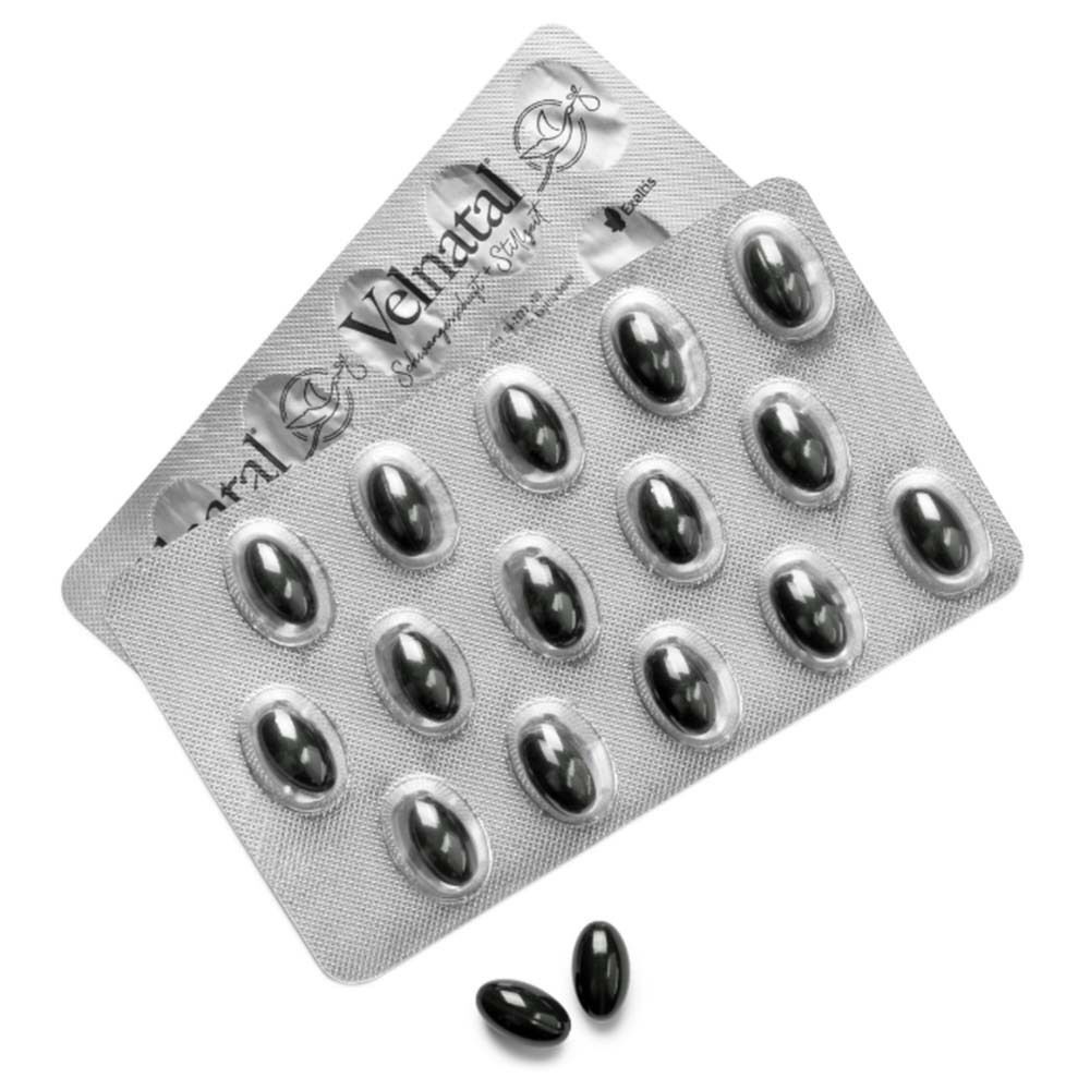 Zwei Blisterpackungen mit schwarzen Kapseln. Eine Kapsel liegt daneben. Velnatal-Logo auf der Verpackung.