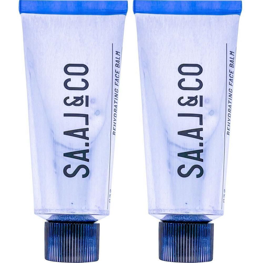 Zwei Tuben SA.A.J&CO REHYDRATING FACE BALM mit blauen Schraubverschlüssen.