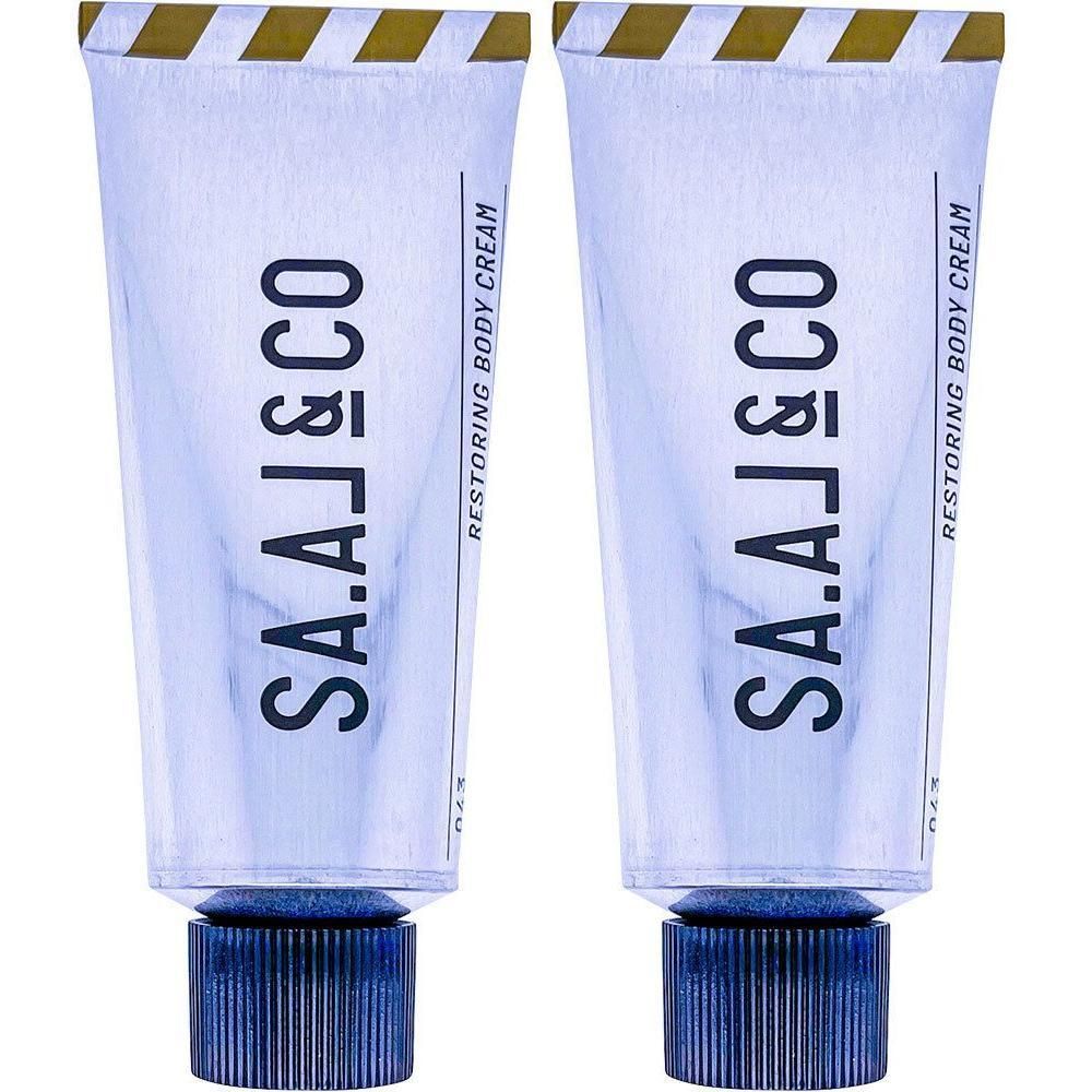 Zwei Tuben SA.AL&CO RESTORING BODY CREAM mit blauen Schraubverschlüssen.