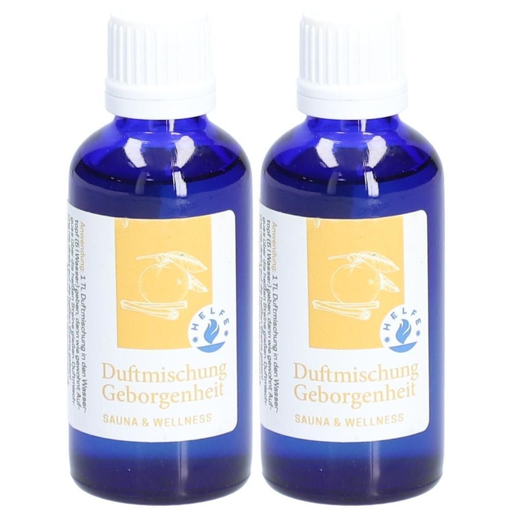 Zwei blaue Glasflaschen mit weißen Deckeln. Etikett mit Produktname und Logo. Aufschrift: Duftmischung Geborgenheit, Sauna & Wellness.