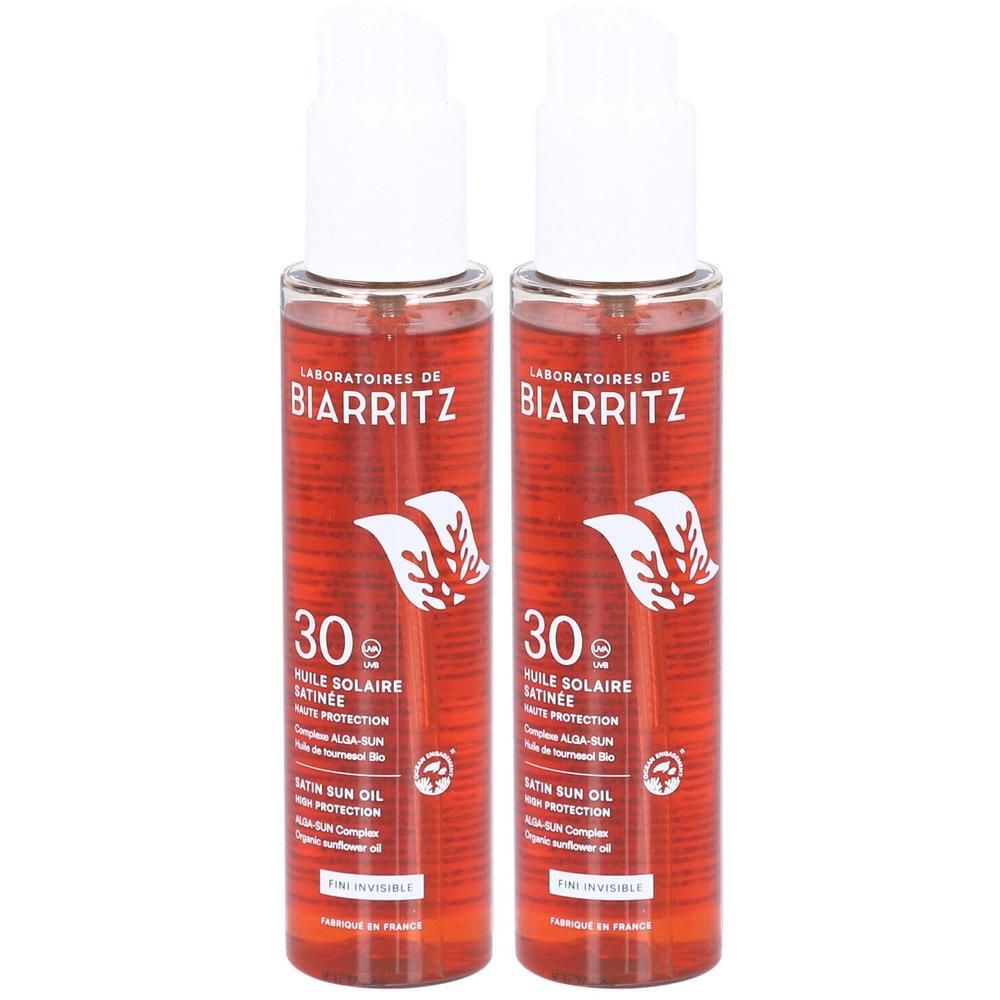 Zwei Flaschen Laboratoires de Biarritz Sonnenschutzöl LSF 30. Rote Flüssigkeit in transparenten Pumpflaschen.