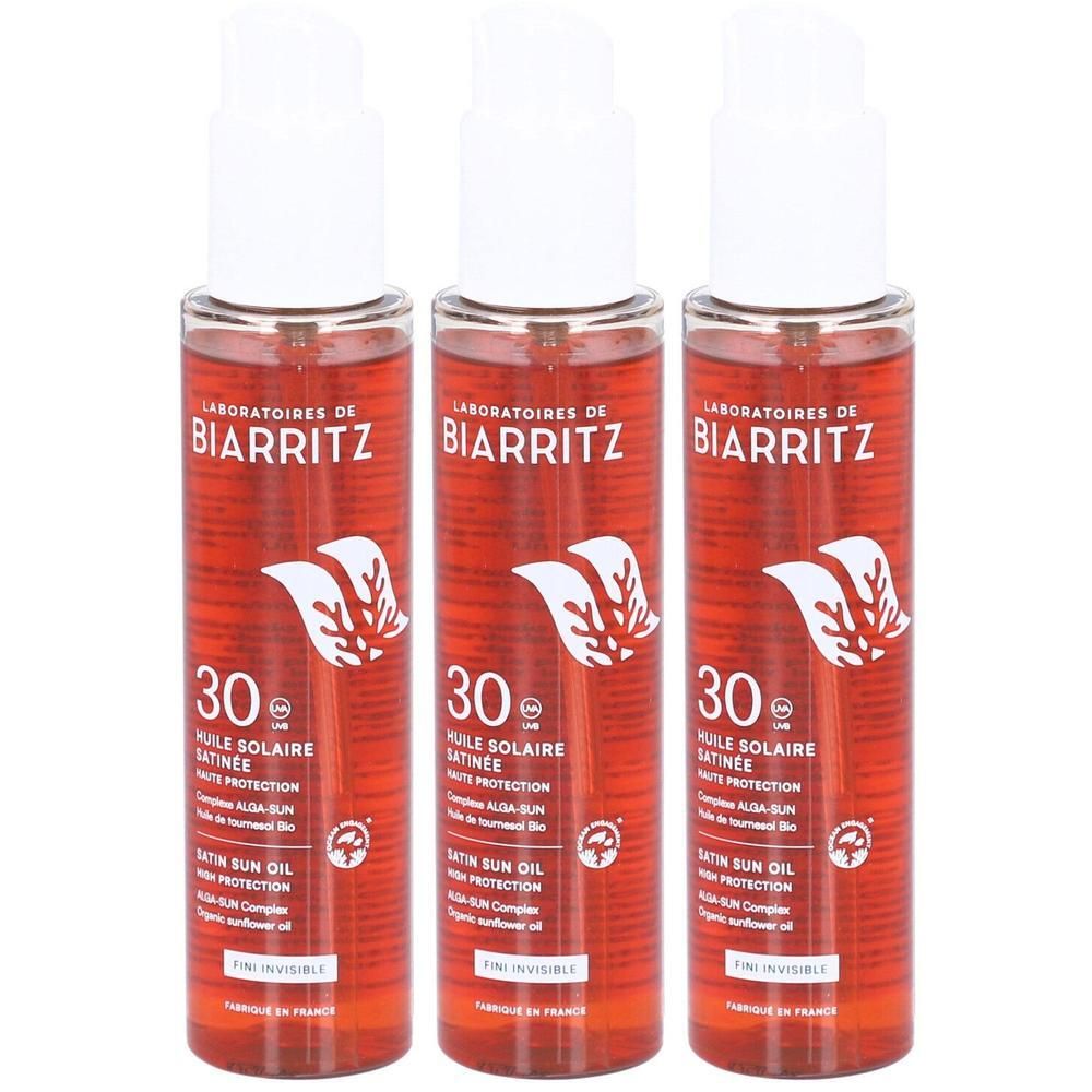 Drei Flaschen Laboratoires de Biarritz Sonnenschutzöl LSF30 mit rotem Etikett und weißem Aufdruck.