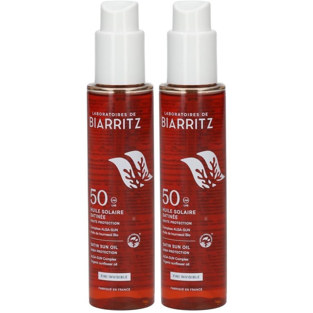 Zwei Flaschen Laboratoires de Biarritz Sonnenschutzöl LSF50. Rote Flaschen mit weißen Pumpaufsätzen.