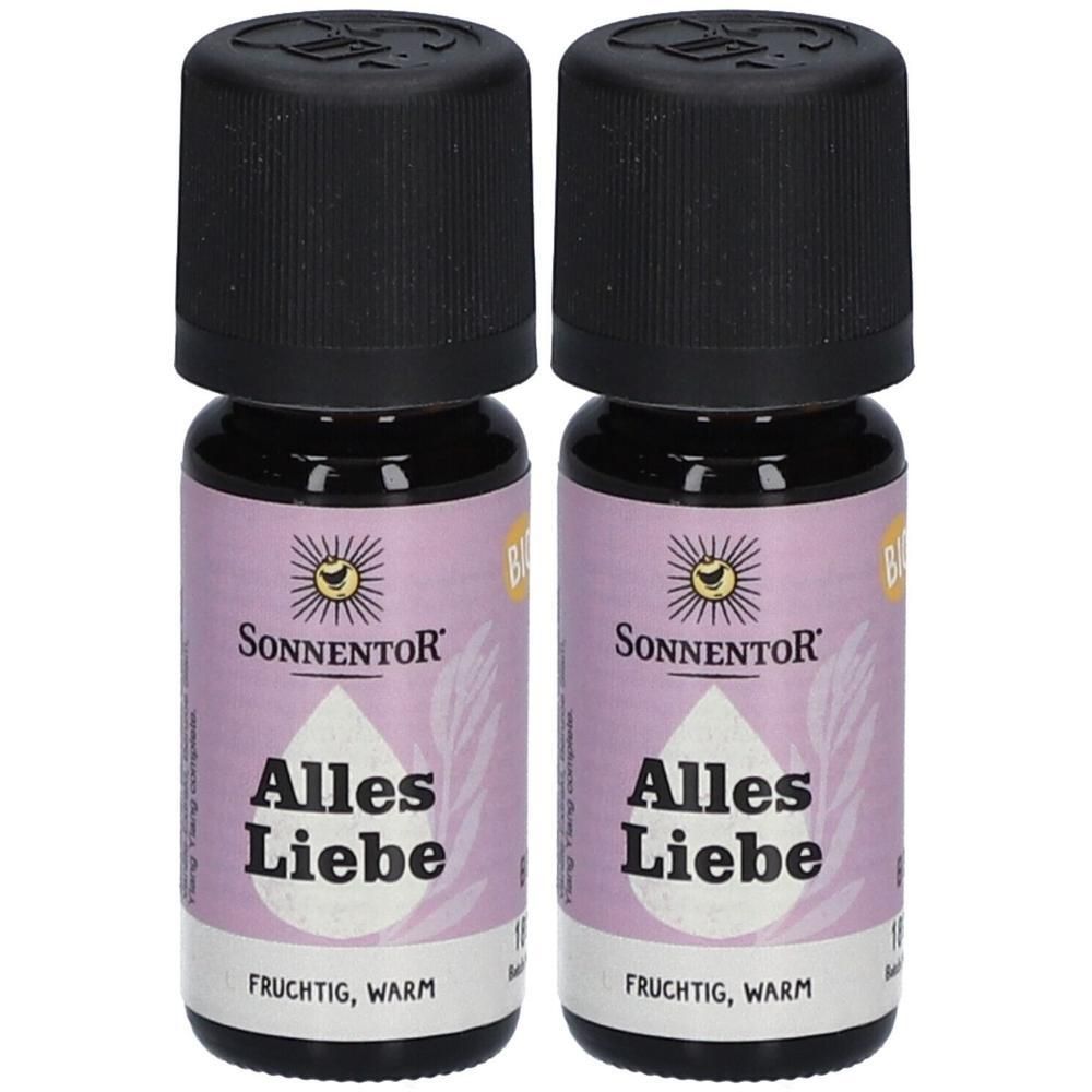 Zwei kleine Flaschen Sonnentor Alles Liebe ätherisches Öl bio. Lila Etikett mit Sonne und Tropfen-Symbol.