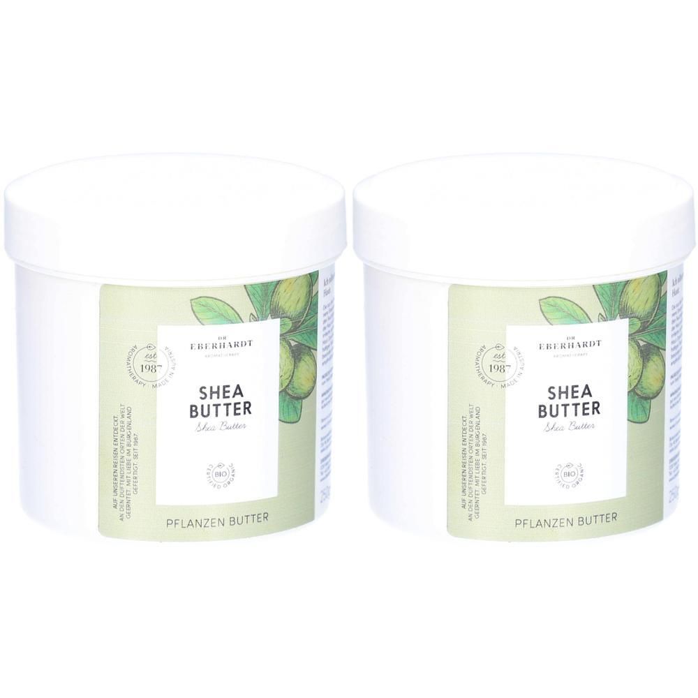 Zwei weiße Tiegel mit Sheabutter, Etiketten zeigen "SHEA BUTTER" und "PFLANZEN BUTTER".