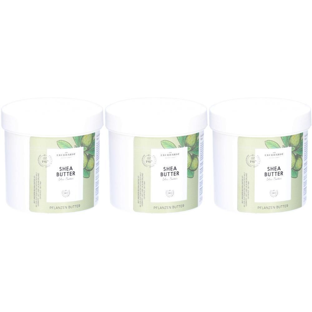 Drei weiße Tiegel mit Sheabutter, Etiketten zeigen grüne Früchte und Text.