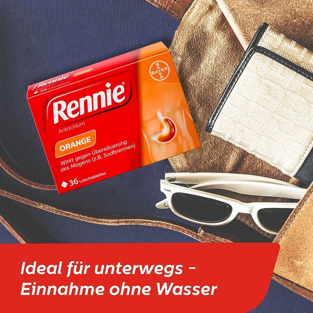 Rennie Orange Packung neben Sonnenbrille und Lederwaren, ideal für unterwegs.