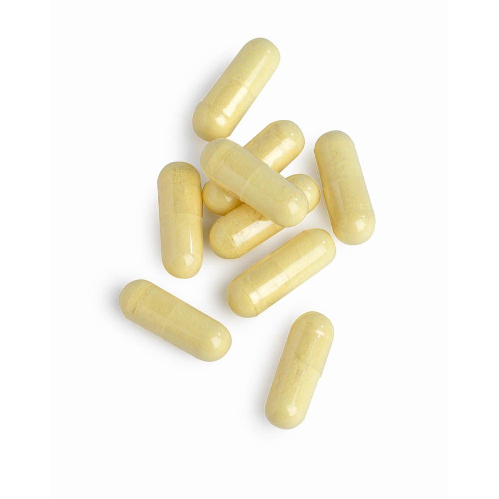 Zehn gelbe Kapseln liegen auf weißem Hintergrund. Keine Verpackung sichtbar.