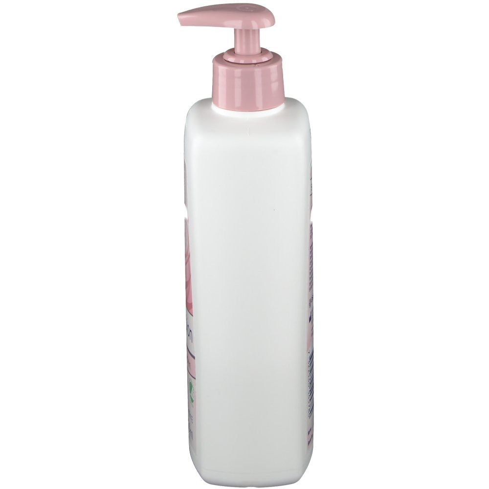 Weiße Flasche mit rosa Pumpkopf. Seitliche Ansicht. Aufdrucke auf der Flasche. Produkt für die Hautpflege.