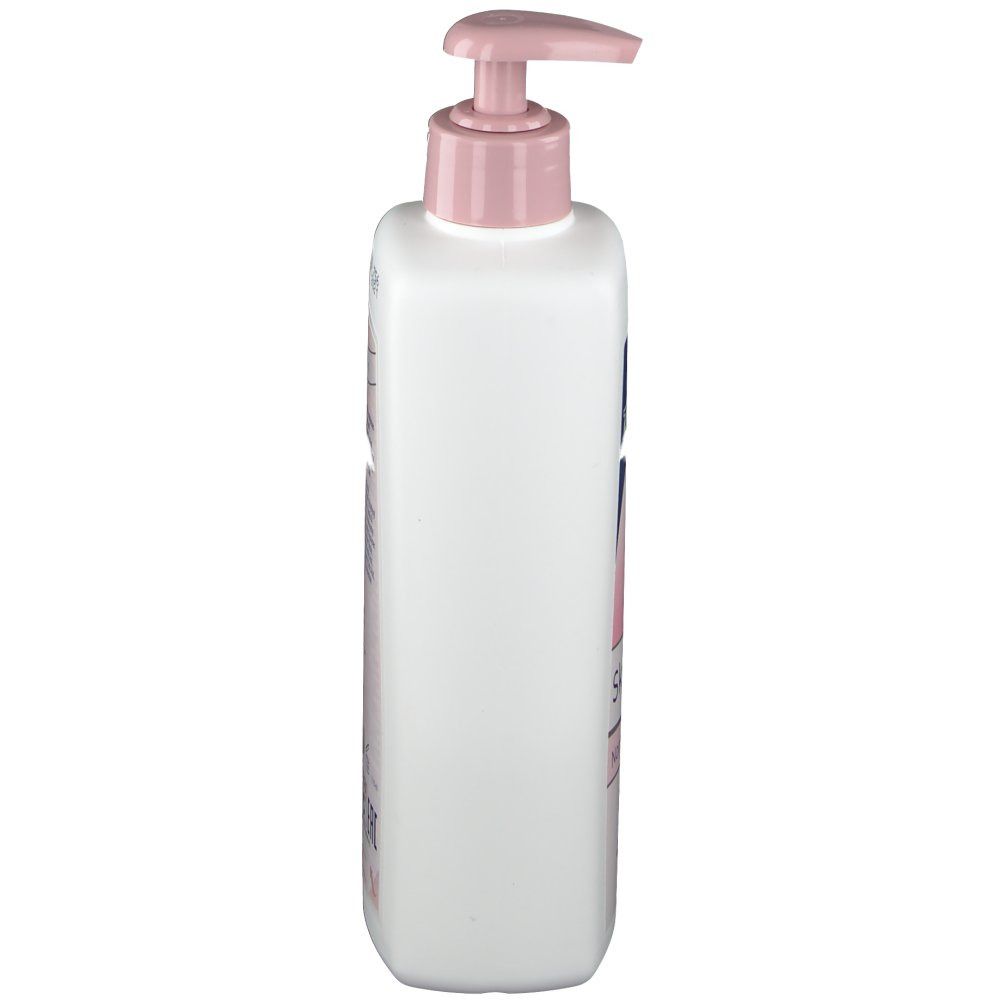 Weiße Flasche mit rosa Pumpkopf. Seitliche Ansicht. Aufdrucke auf der Flasche. Produkt für die Hautpflege.