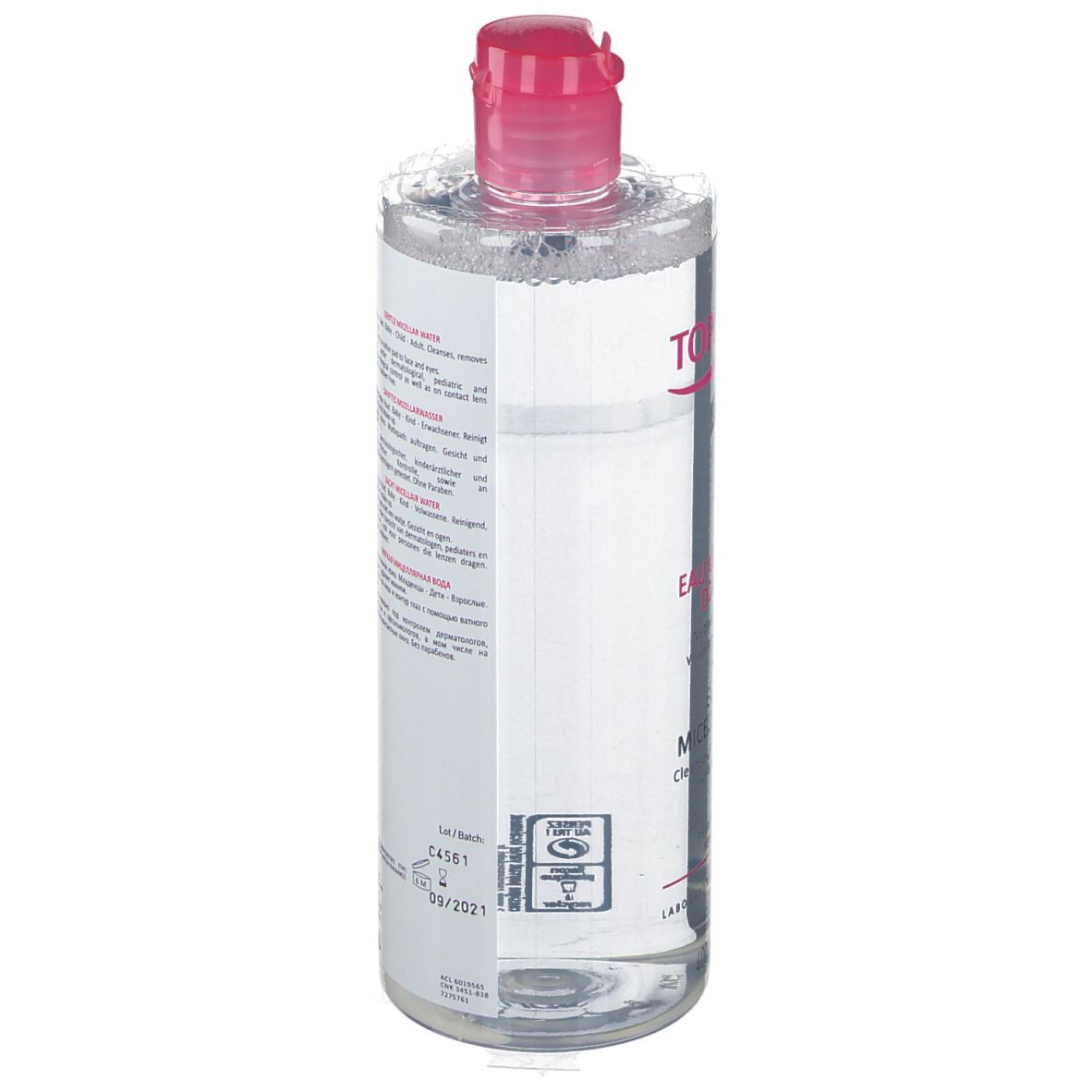 Transparente Flasche mit rosa Deckel. Etikett mit Text in mehreren Sprachen. Produkt für empfindliche Haut.