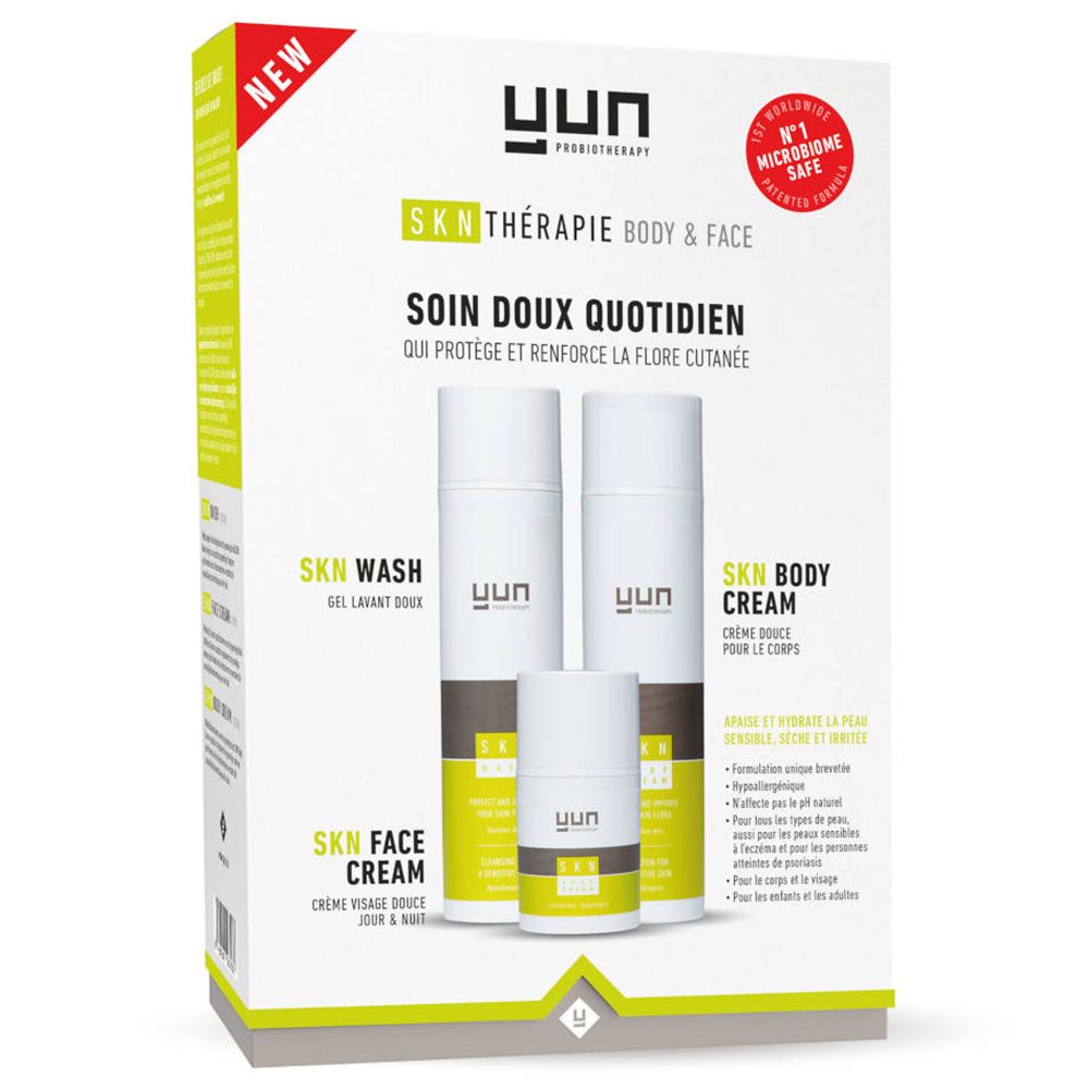 Verpackung mit drei YUN SKN Therapy Produkten: Waschgel, Körpercreme und Gesichtscreme. Weiß, grün und braun.