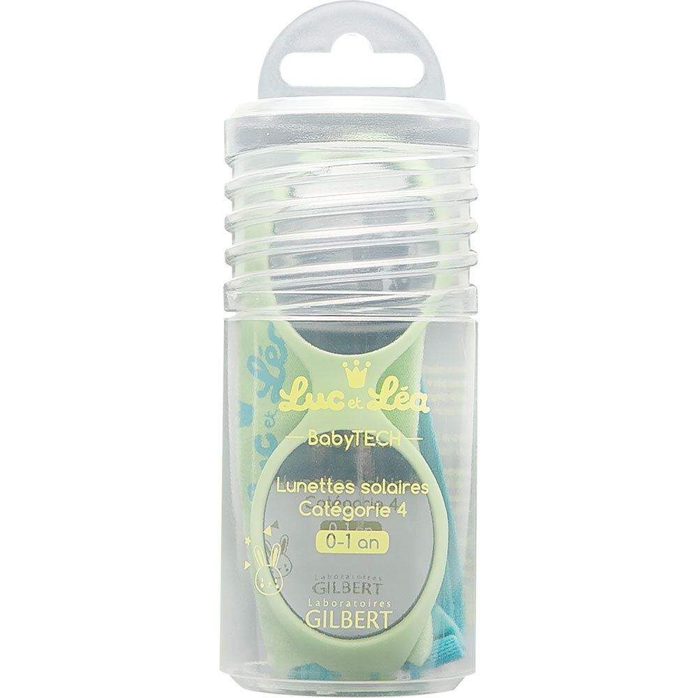 Grüne Baby-Sonnenbrille in transparenter Verpackung. Produktinformationen auf der Verpackung.