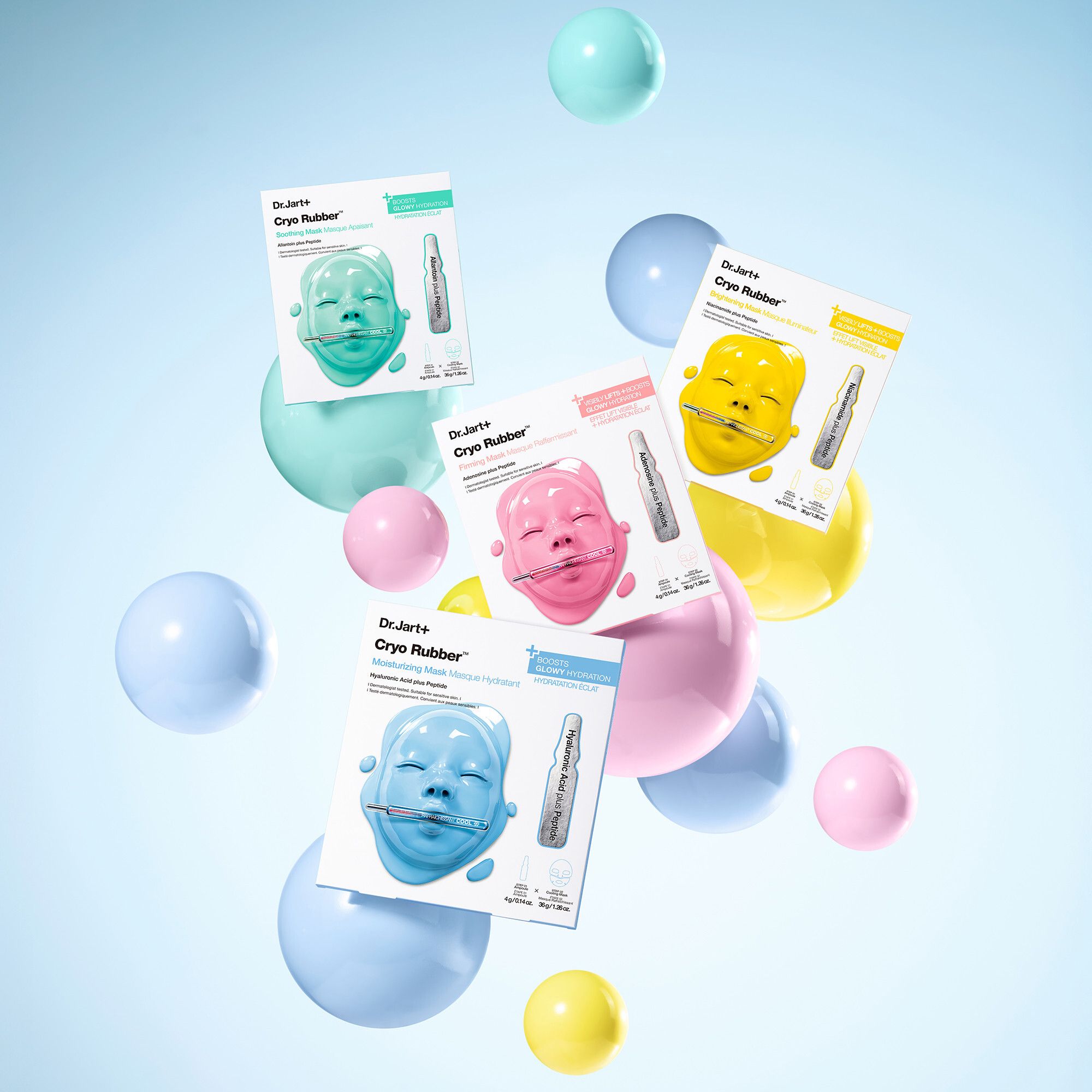 Mehrere Verpackungen von Dr.Jart+ Cryo Rubber Mask. Verschiedene Farben. Schwebende Kugeln im Hintergrund.