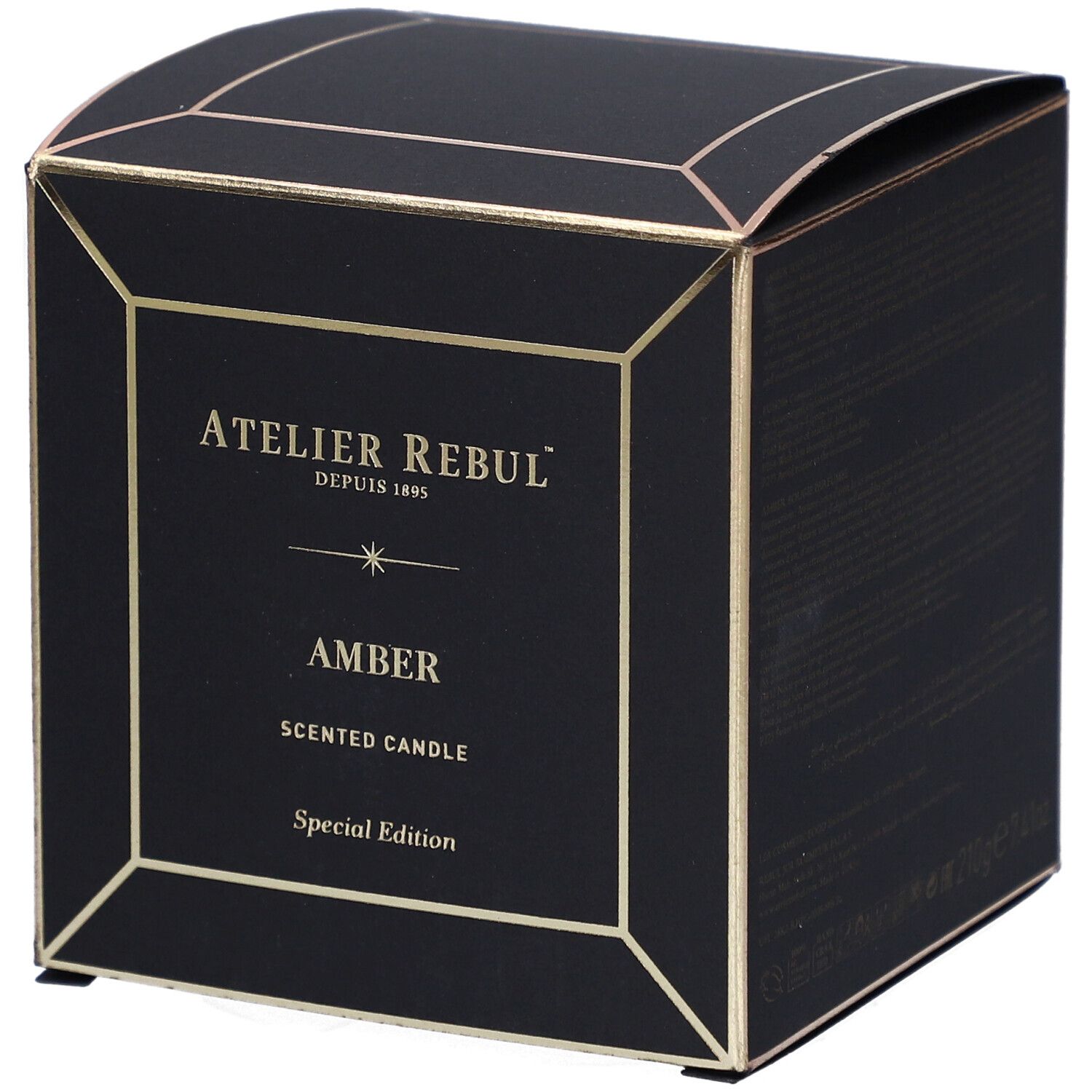 Schwarze quadratische Schachtel mit goldfarbenen Akzenten. Auf der Vorderseite steht "ATELIER REBUL", "AMBER" und "SCENTED CANDLE".