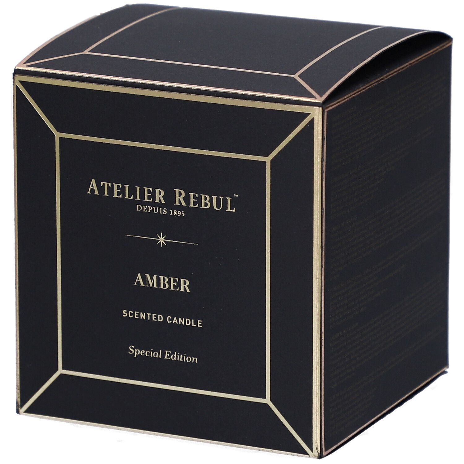 Schwarze quadratische Schachtel mit goldfarbenen Akzenten. Auf der Vorderseite steht "ATELIER REBUL", "AMBER" und "SCENTED CANDLE".
