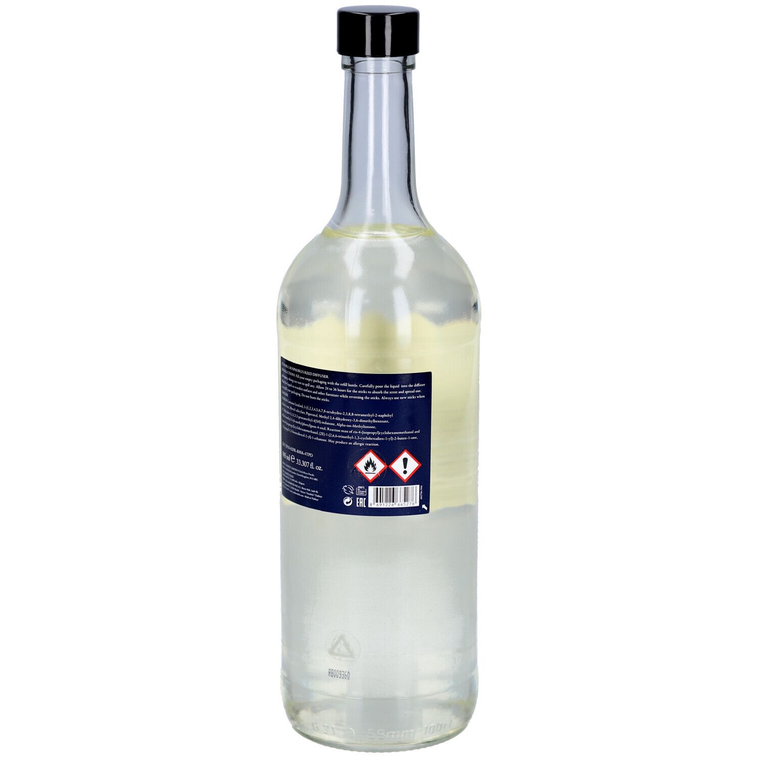 Glasflasche mit schwarzem Deckel und Etikett. Rückseite mit Warnhinweisen und Barcode. Aufschrift: Atelier Rebul.