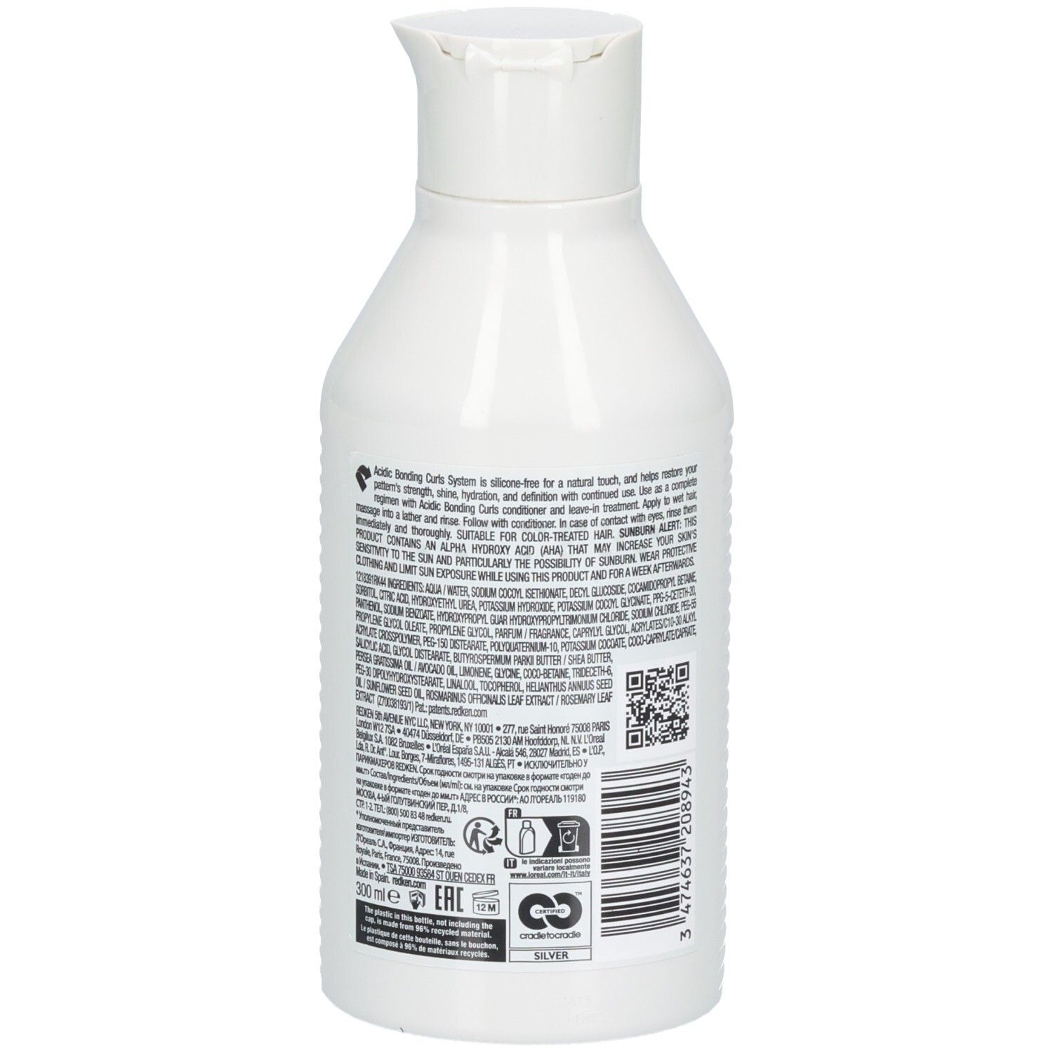 Rückseite einer weißen Redken-Flasche. Text mit Inhaltsstoffen und QR-Code. 300 ml. Silber-Recycling-Logo.