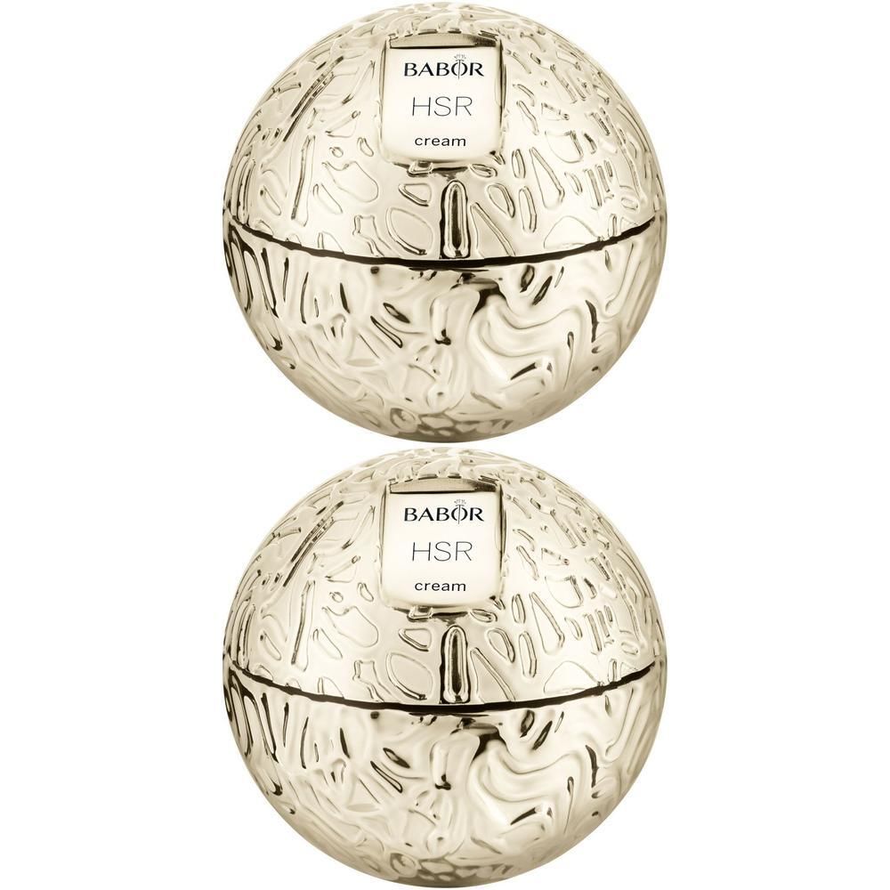 Zwei goldfarbene Cremetiegel mit dem Schriftzug Babor HSR cream. Die Tiegel haben eine kugelförmige Form mit geprägtem Muster.