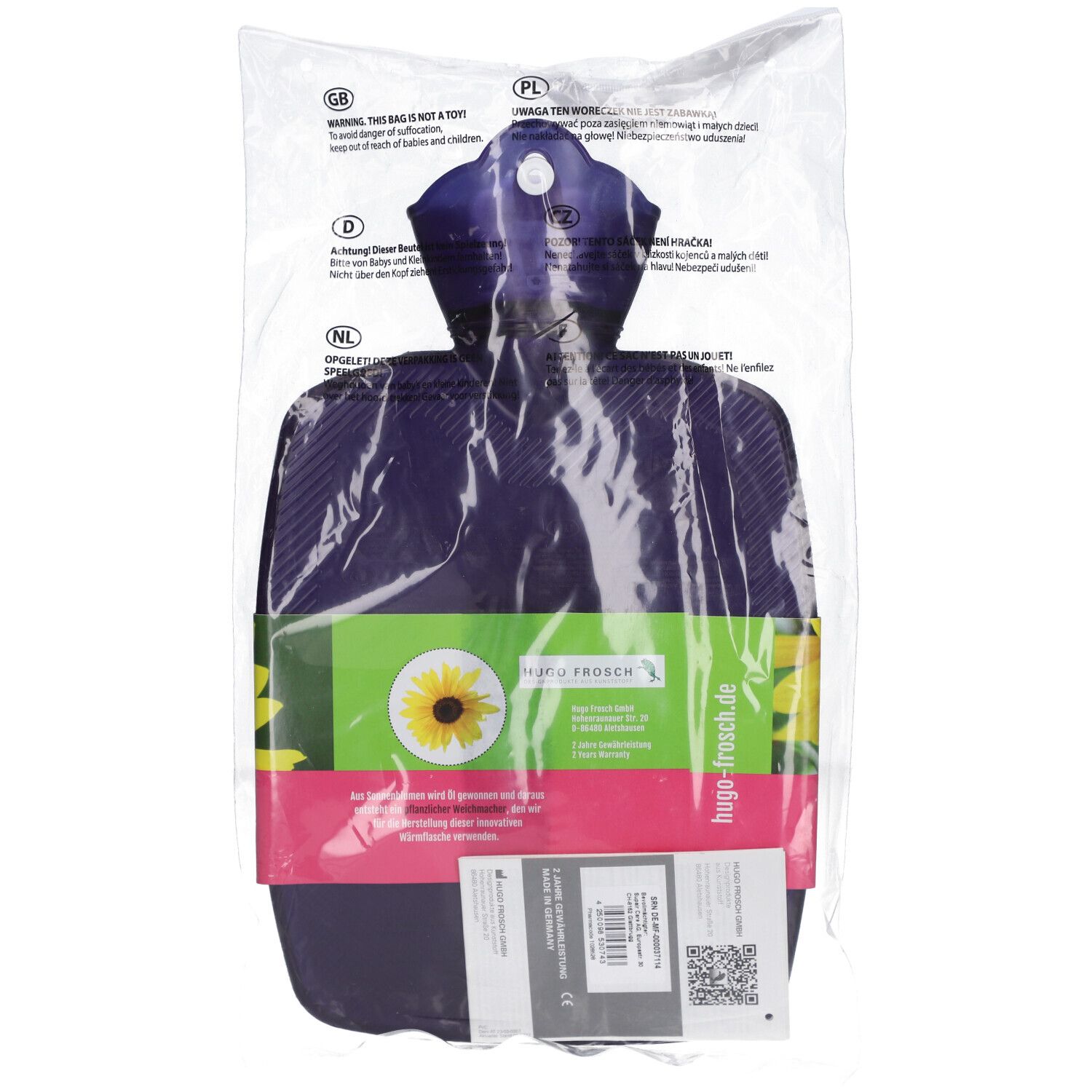 Violette Wärmflasche in Verpackung. Mit Sonnenblumenmotiv und Etikett. Marke: HUGO FROSCH. Aufschrift: hugo-frosch.de.