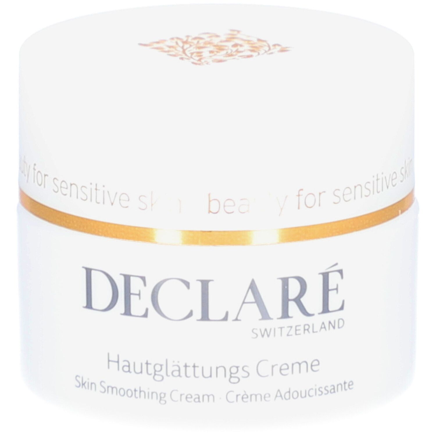 Weißer Creme-Tiegel mit goldfarbenem Rand. Aufschrift: DECLARÉ, Hautglättungs Creme. Text: Skin Smoothing Cream, Crème Adoucissante.