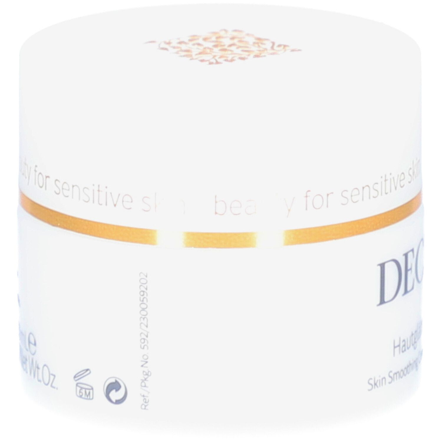 Weißer Creme-Tiegel mit goldfarbenem Rand. Aufschrift: DECLARÉ, Hautglättungs Creme. Text: Skin Smoothing Cream, Crème Adoucissante.