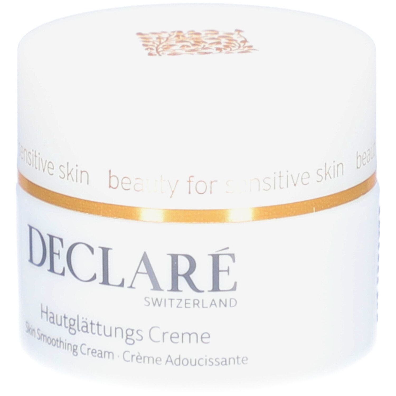 Weißer Creme-Tiegel mit goldfarbenem Rand. Aufschrift: DECLARÉ, Hautglättungs Creme. Text: Skin Smoothing Cream, Crème Adoucissante.