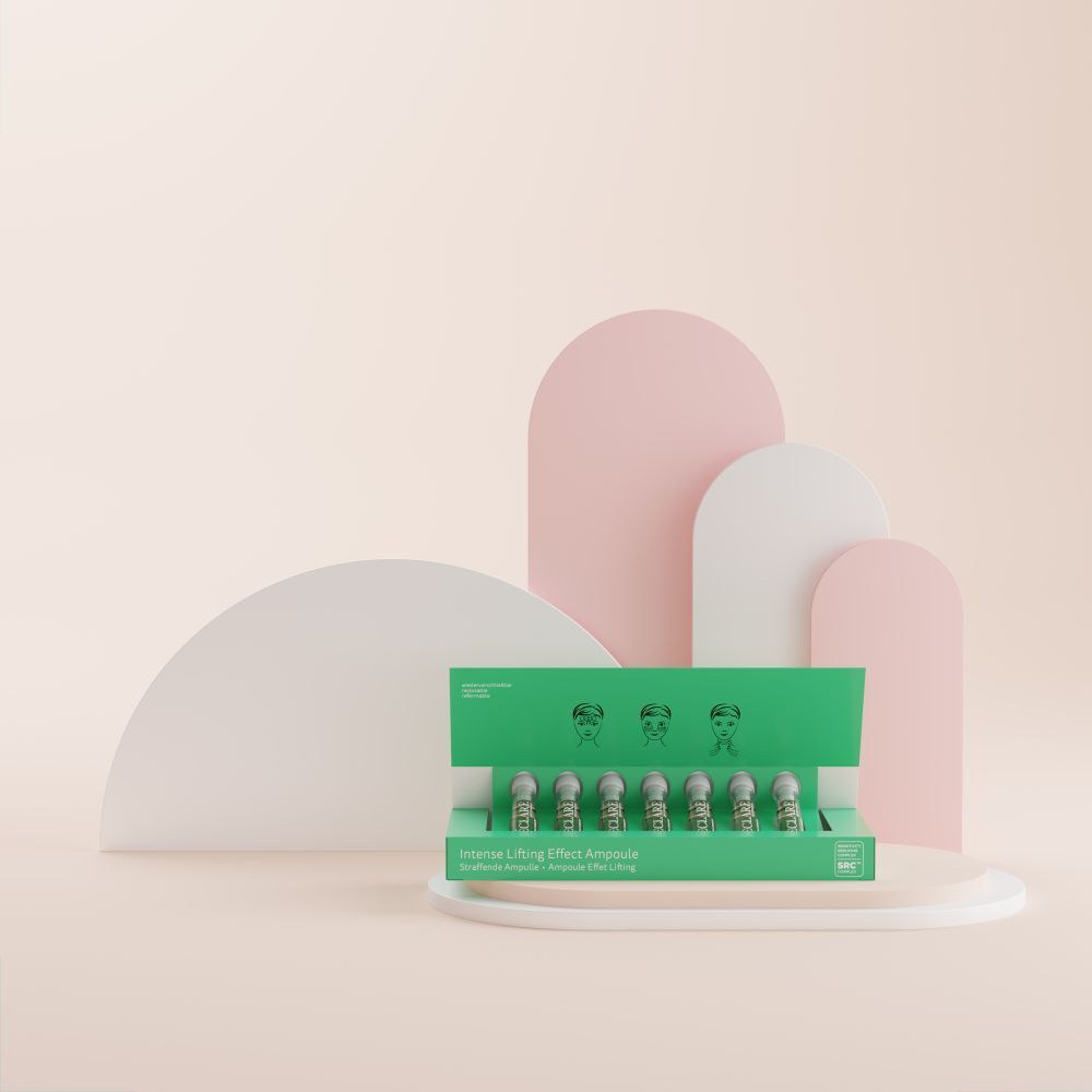 Grüne Schachtel mit Ampullen. Aufschrift: Intense Lifting Effect Ampoule. Auf rosa und weißem Hintergrund.