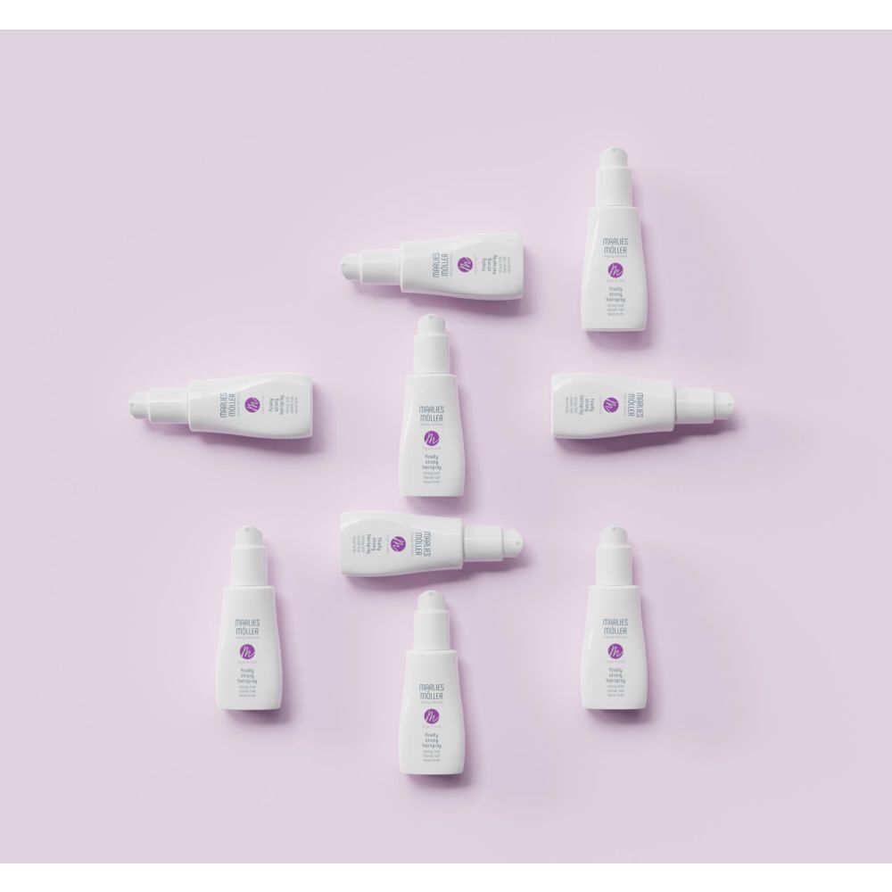 Mehrere Haarspray-Flaschen auf lila Hintergrund. Marlies Möller Logo und Produktbezeichnung.