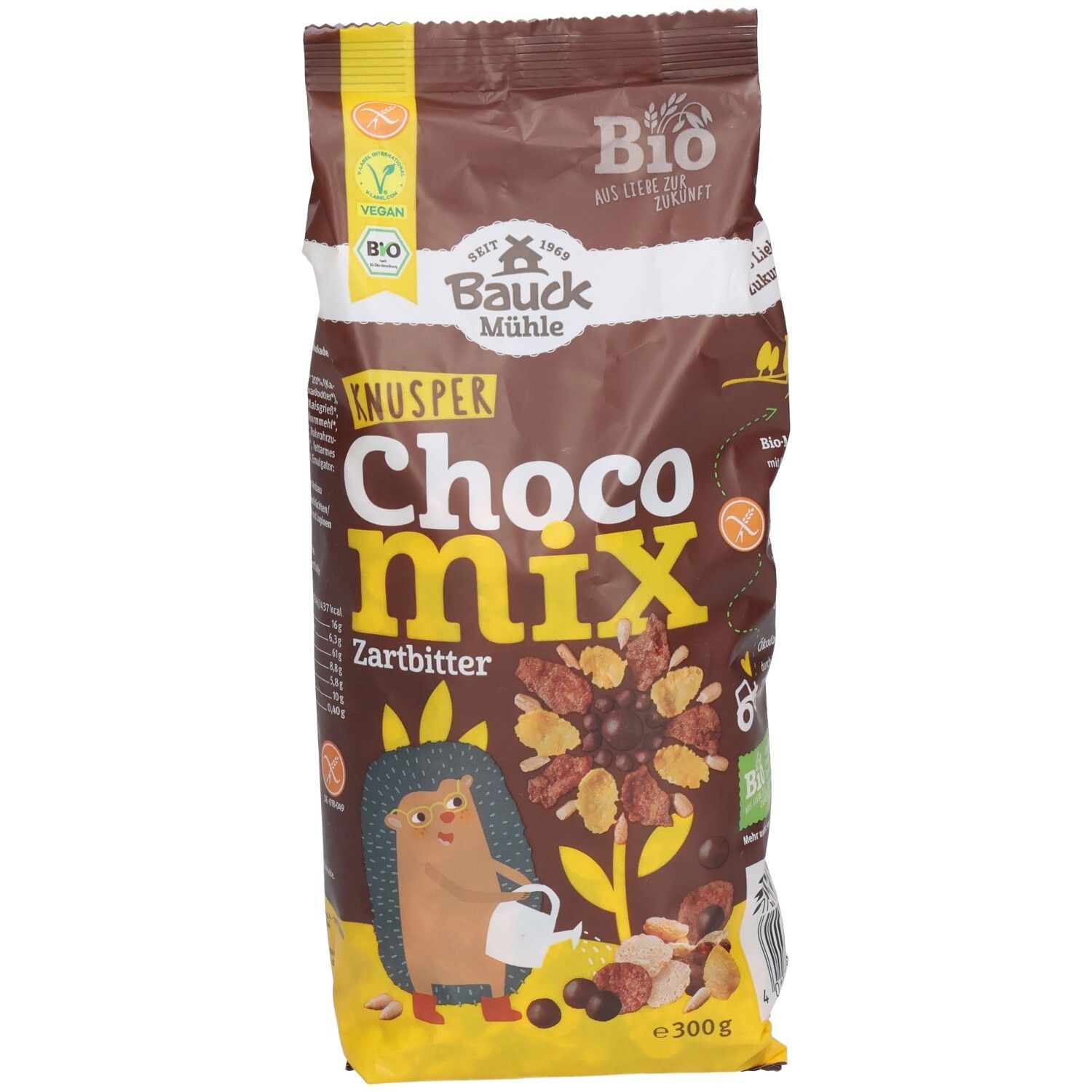 Braune Tüte mit Aufschrift "KNUSPER Choco Mix Zartbitter". Vegan- und Bio-Siegel. Abbildung eines Igels und Cerealien.