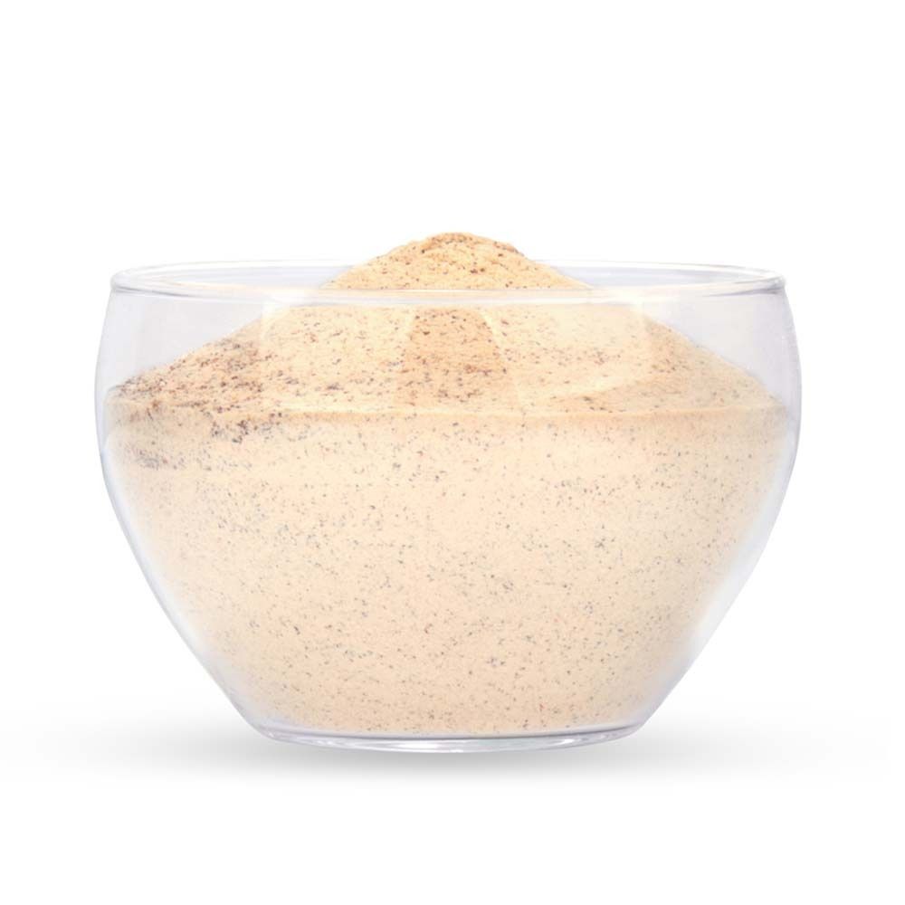 Transparente Glasschale mit hellbraunem Pulver. Pulver ist leicht gewölbt.