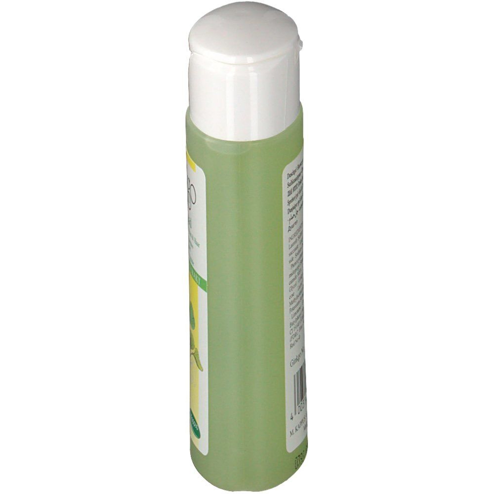 Grüne Flasche mit weißem Deckel, Seitenansicht. Etikett teilweise sichtbar.