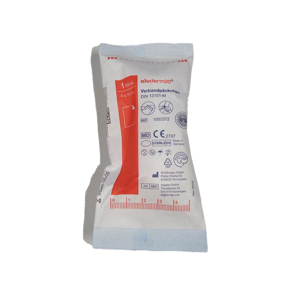 Verbandpäckchen in weißer Verpackung. Aufdrucke: aluderm, DIN 13151-M, CE-Zeichen. Sichtbar: 6 x 8 cm. Einzelverpackt.