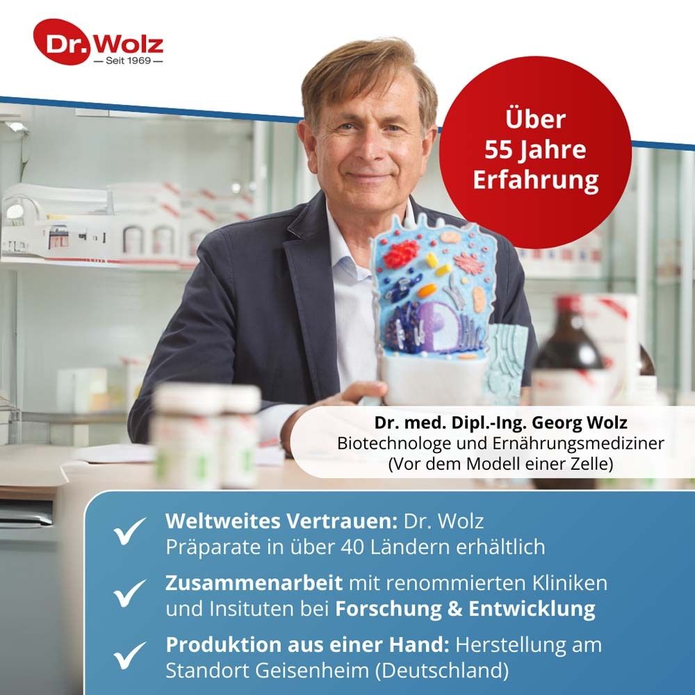Mann mit Modell einer Zelle. Text: Über 55 Jahre Erfahrung. Dr. med. Dipl.-Ing. Georg Wolz.