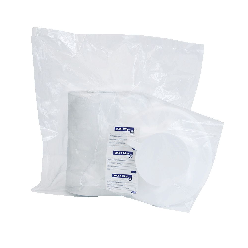 Rolle Vliestücher in transparenter Verpackung. Etikett mit Produktinformationen. Runde Vliestücher sichtbar.