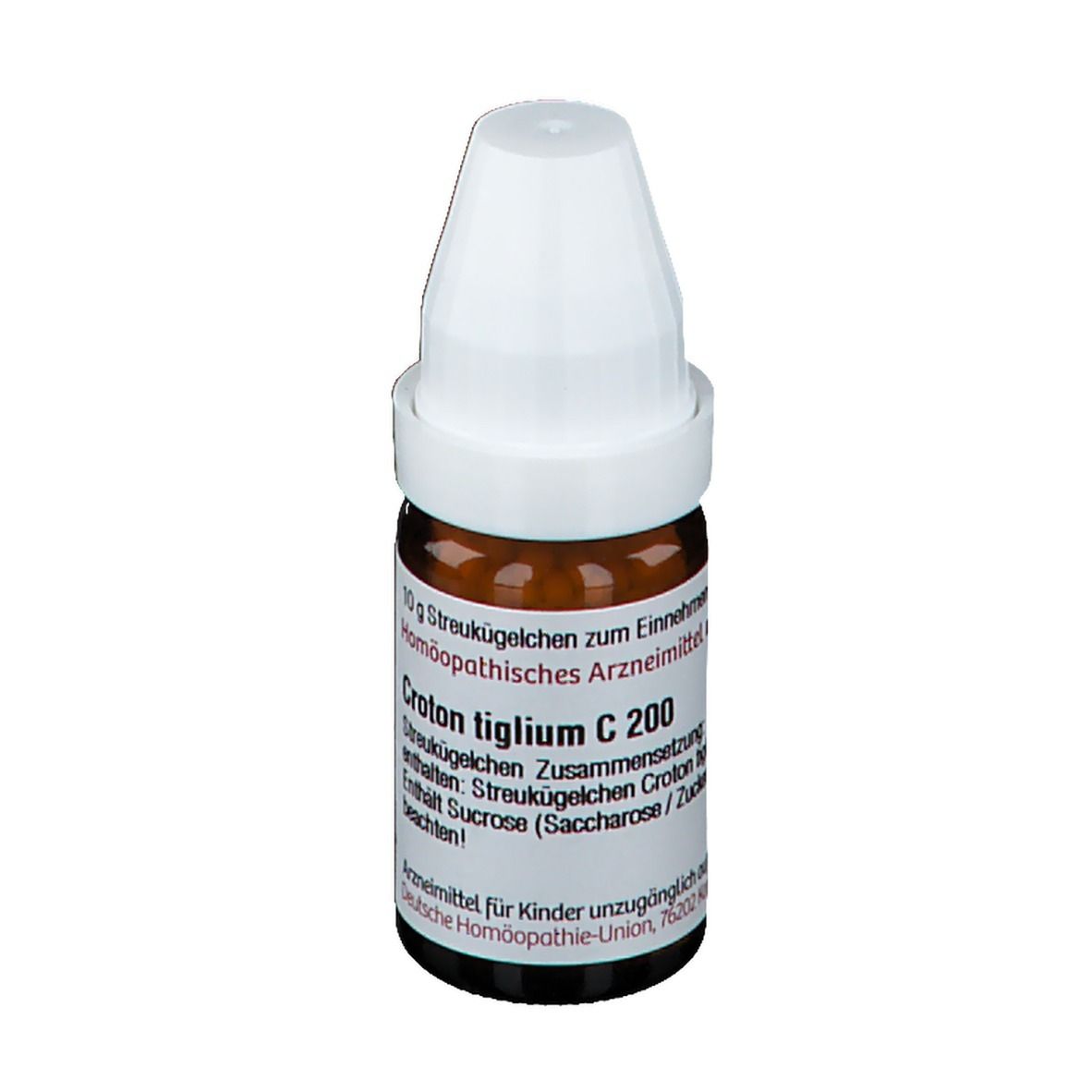 Braune Glasflasche mit weißem Deckel. Beschriftung: Croton tiglium C 200. Enthält Streukügelchen. Deutsche Homöopathie-Union.
