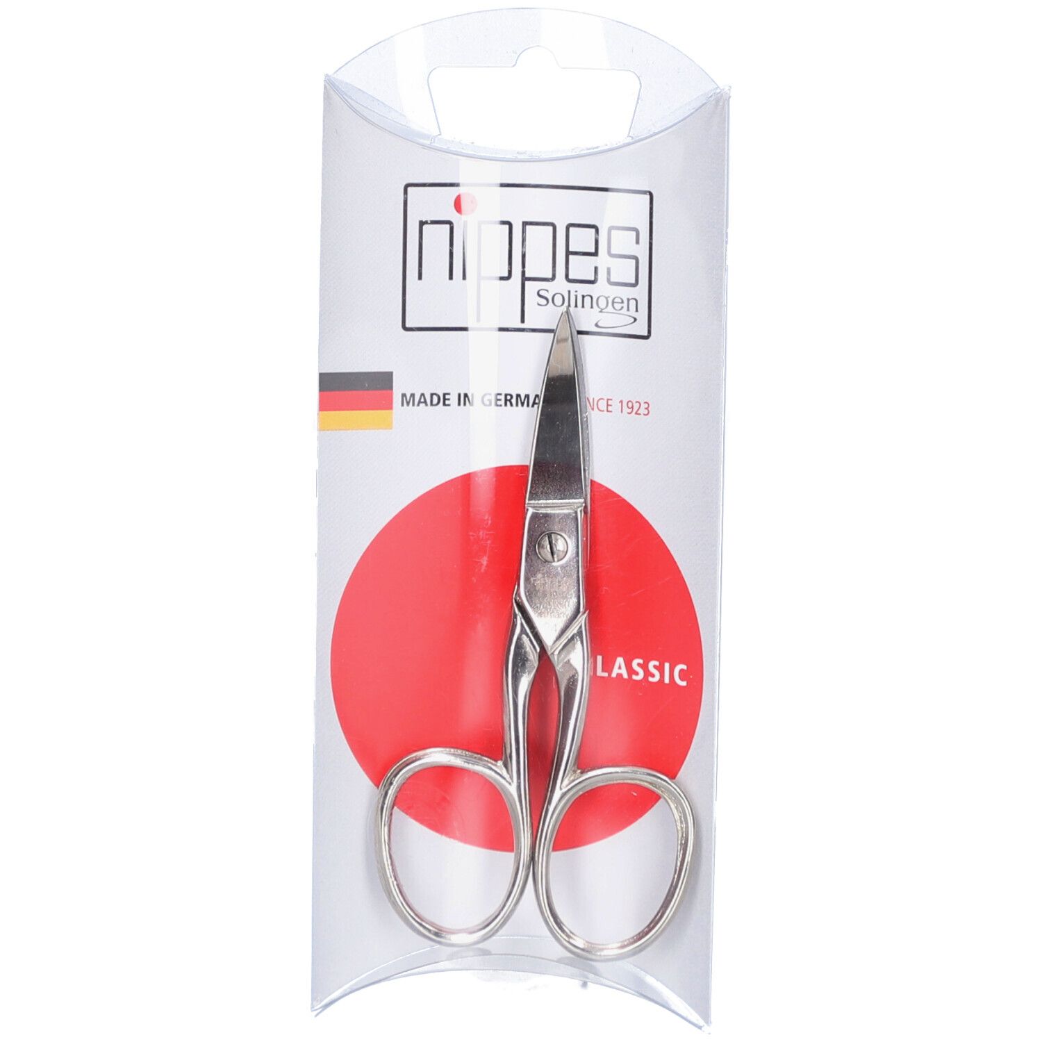 Fußnagelschere in transparenter Verpackung. Silberfarbenes Metall, abgerundete Griffe, spitz zulaufende Klingen. "nippes Solingen"-Logo.
