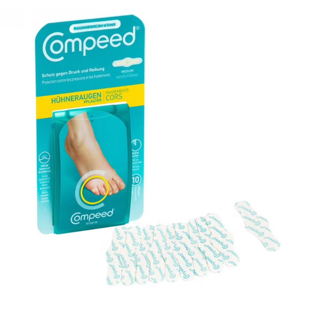 Compeed® Hühneraugenpflaster Medium Verpackung und einige Pflaster. 10 Pflaster. Produktname und Logo sichtbar.