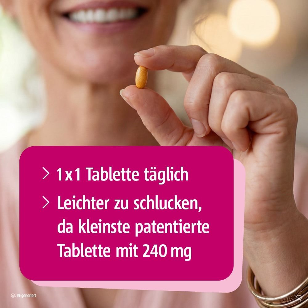 Frau hält eine kleine, ovale Tablette zwischen Daumen und Zeigefinger.