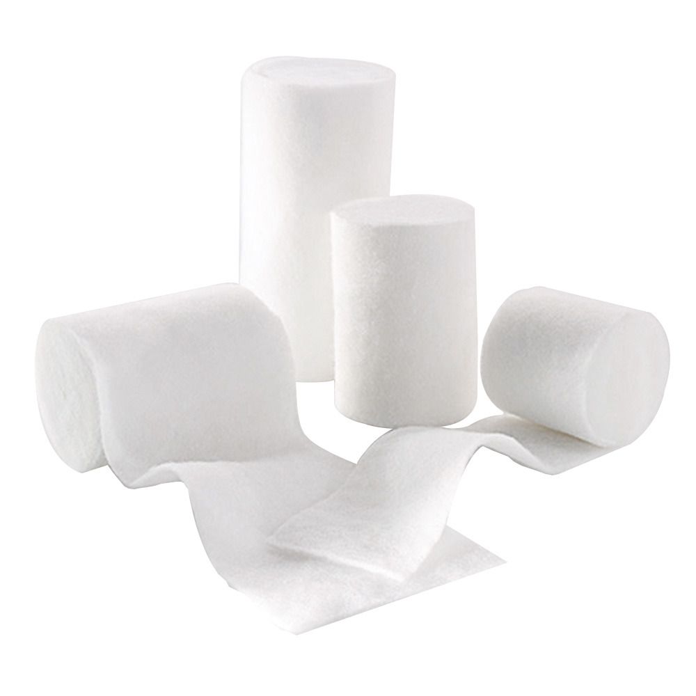 Mehrere Rollen und Bahnen Watte. Einige aufgerollt, andere ausgerollt. Weißes, weiches Material.