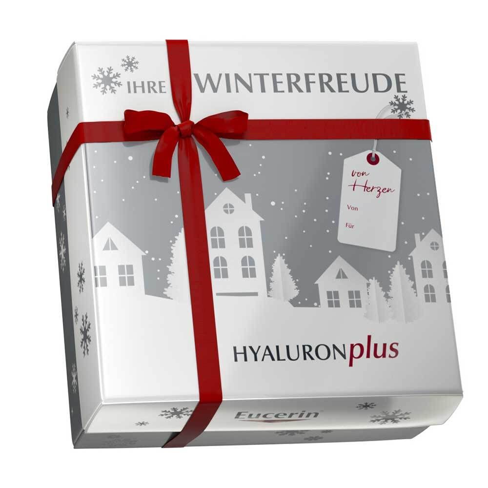 Geschenkbox mit roter Schleife. Aufschrift: Ihre Winterfreude, Hyaluronplus, Eucerin. Schneeflocken-Design.