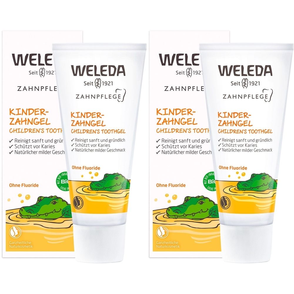 Zahncreme-Tuben und -Verpackungen. Aufschrift: Kinder-Zahngel, Children's Toothgel. Ohne Fluoride. Mit Krokodil-Illustration.