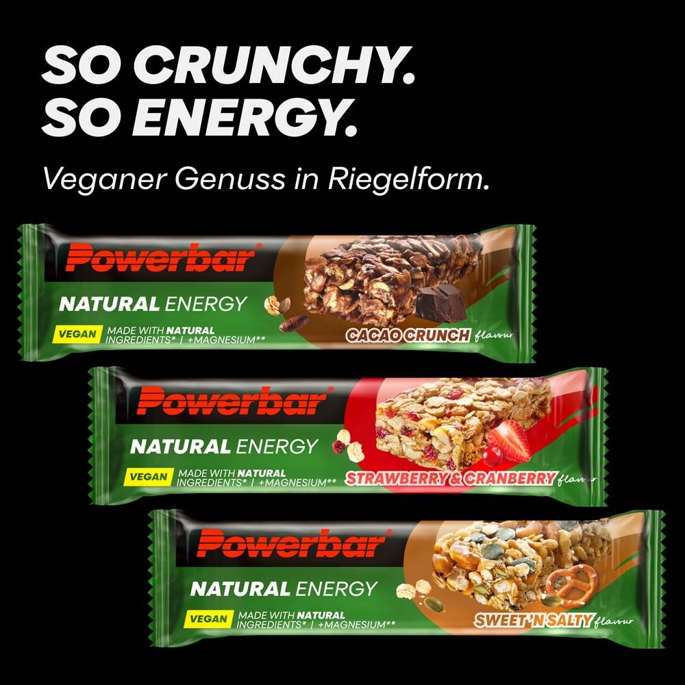 Drei PowerBar Natural Energy Riegel. Cacao Crunch, Erdbeer-Cranberry, Sweet 'n Salty. Vegan. Schwarzer Hintergrund. Riegel in Riegelform.