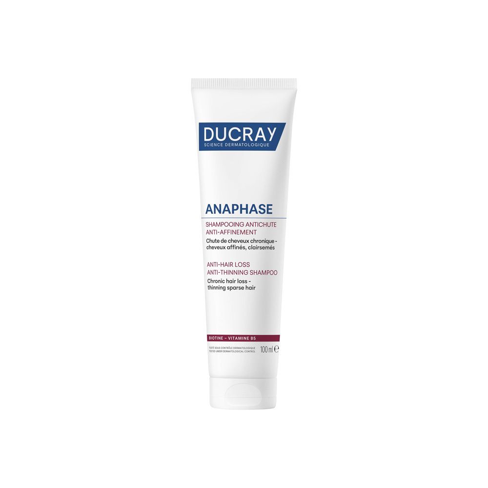 Weiß-blaue Tube. Aufschrift: DUCRAY, ANAPHASE, Shampooing antichute, Anti-Haarausfall Shampoo. Text in Französisch und Englisch.