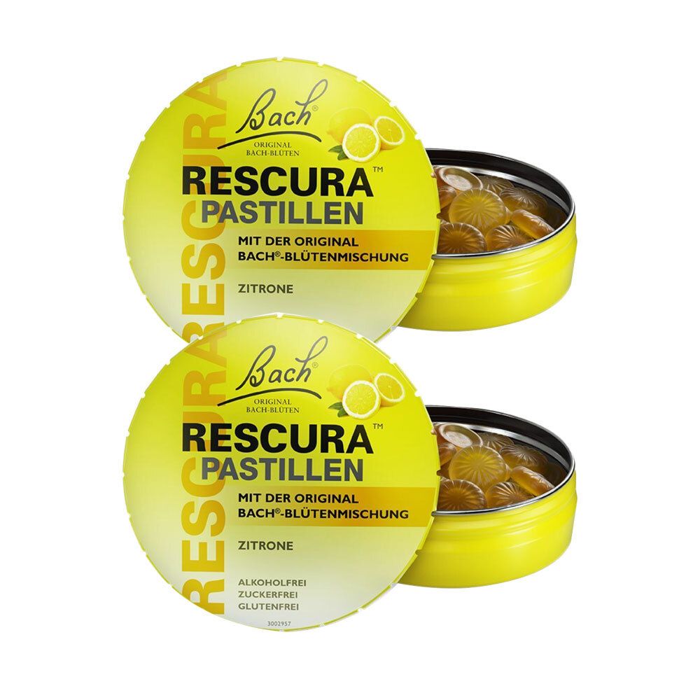Zwei gelbe Dosen RESCURA Pastillen Zitrone. Deckel mit Logo und Produktbezeichnung. Offene Dose mit Pastillen.