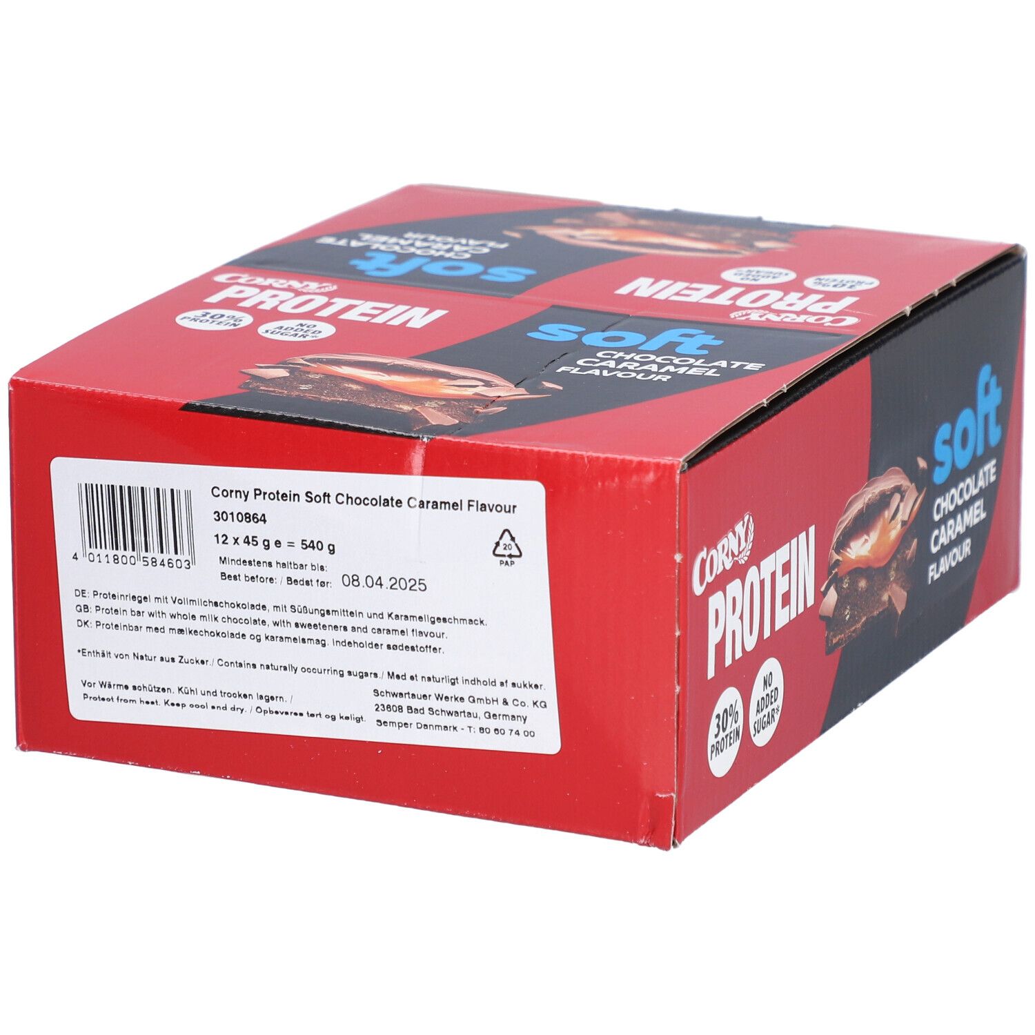 Rote und schwarze Schachtel mit Corny Protein Soft. Aufdruck: Schokolade-Karamell-Geschmack, 30% Protein, ohne Zuckerzusatz. Etikett mit Inhaltsangaben.