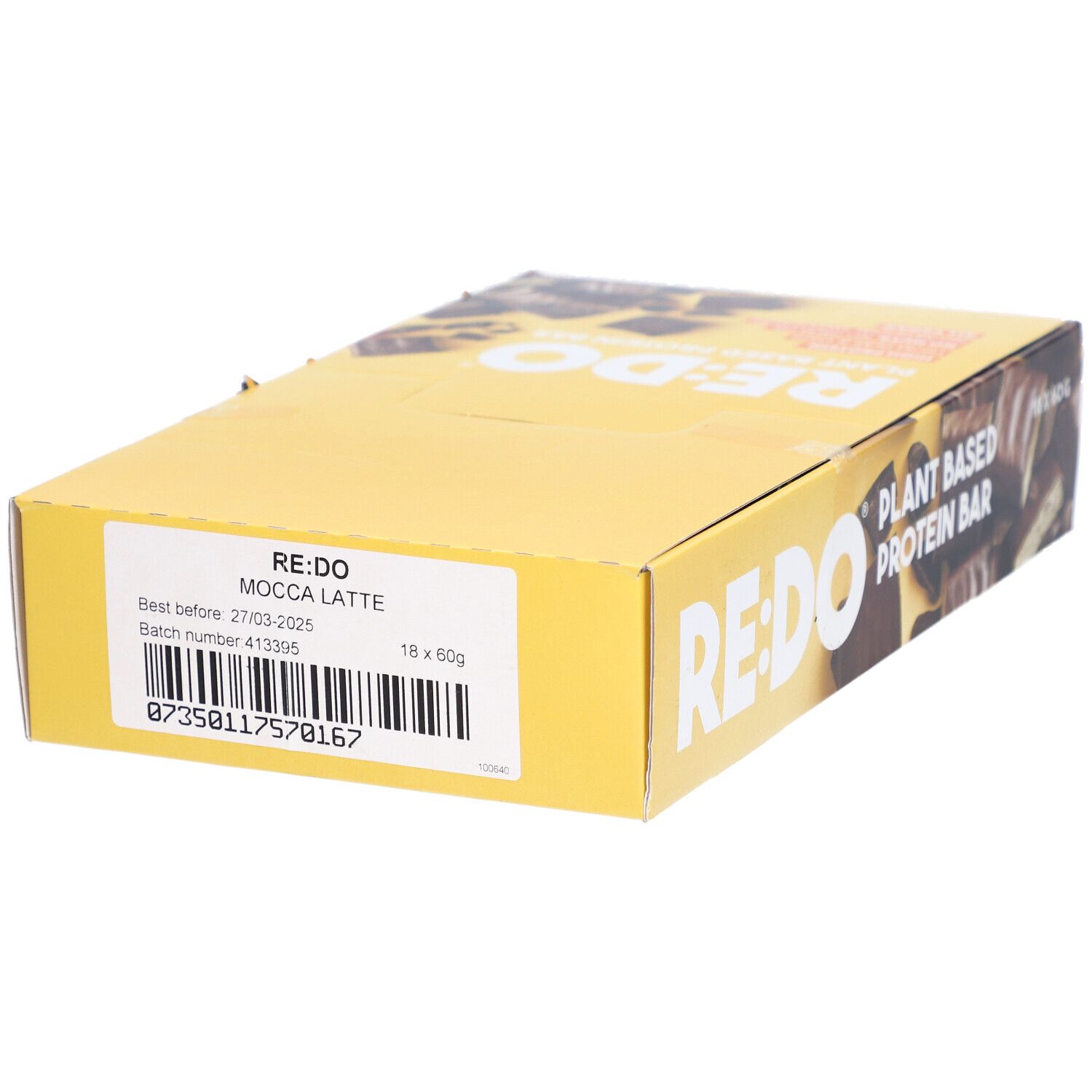 Gelbe Kartonverpackung mit RE:DO-Logo und Text. Aufschrift: Mocca Latte, 18 x 60g. Etikett mit Mindesthaltbarkeitsdatum und Chargennummer.