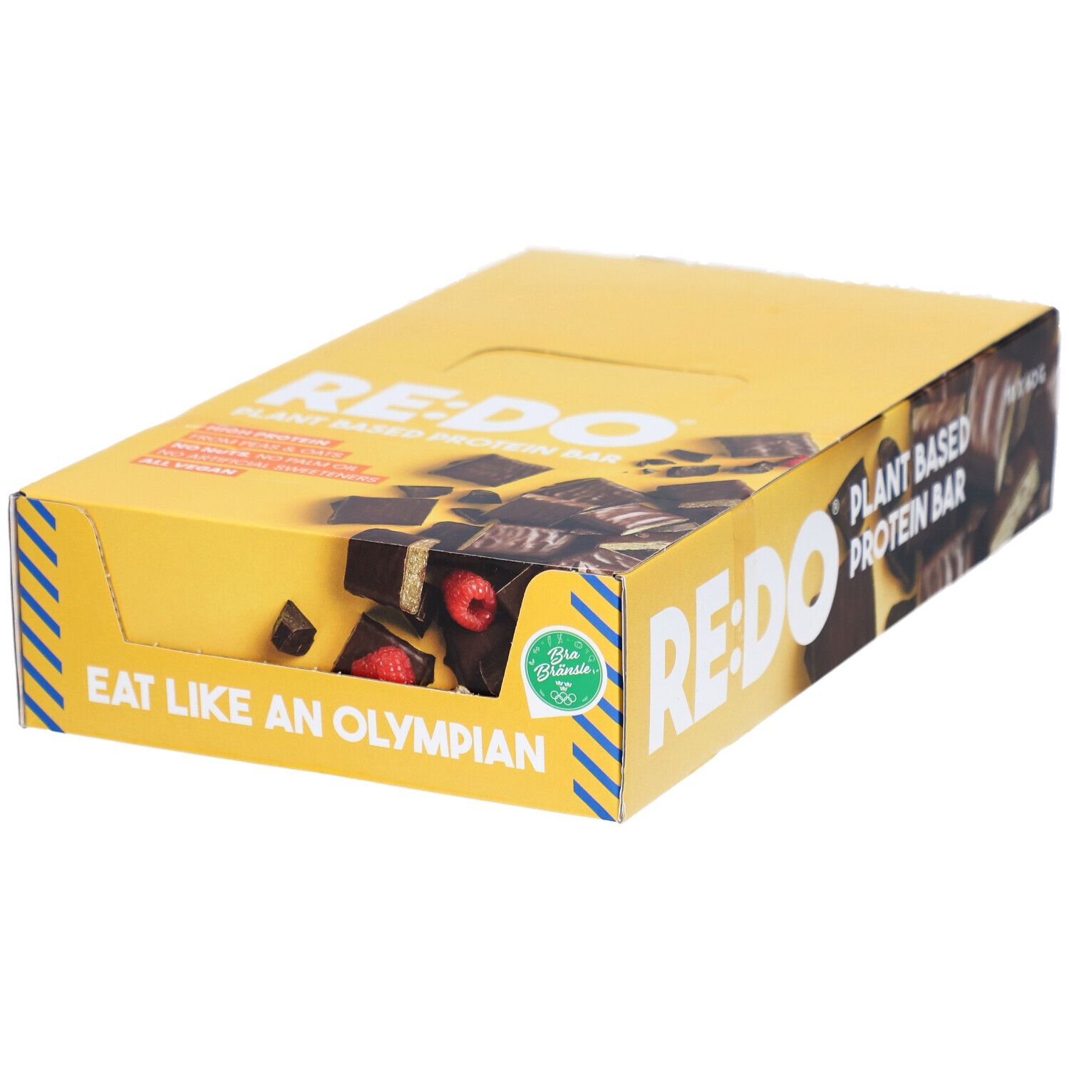 Gelbe Schachtel mit RE:DO-Schokoriegeln. Aufschrift: Plant Based Protein Bar. Sichtbar: Riegelstücke mit Himbeeren. Aufschrift: Eat like an Olympian.